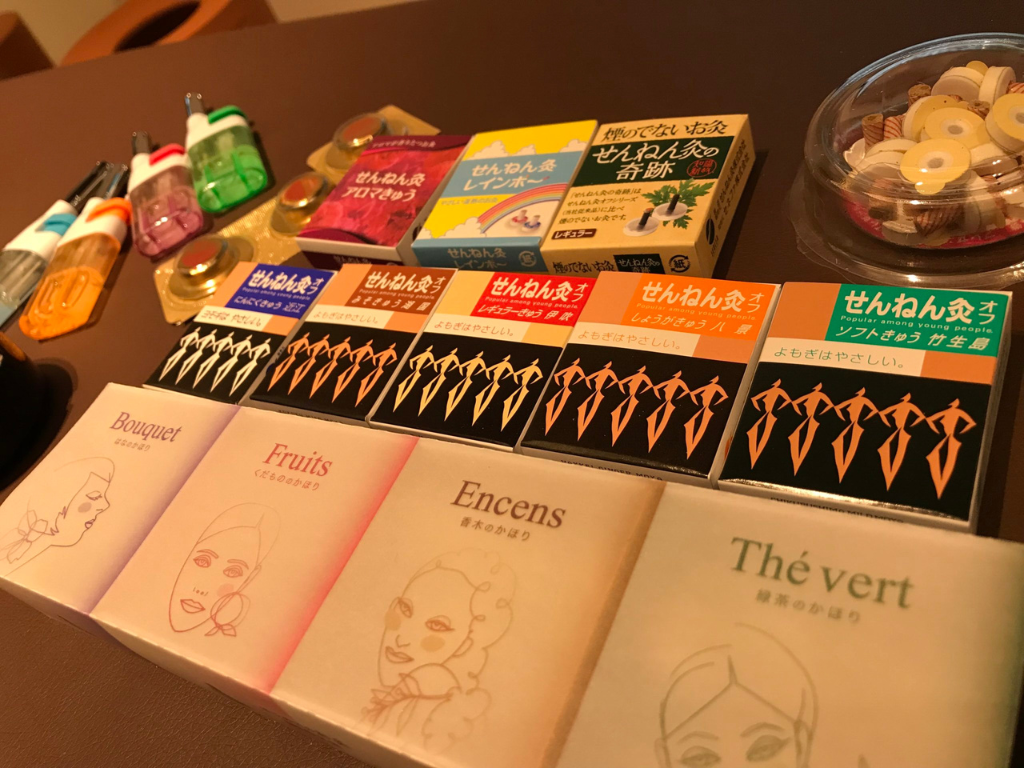 机に並んだ各種せんねん灸とアロマきゅうの商品パッケージ